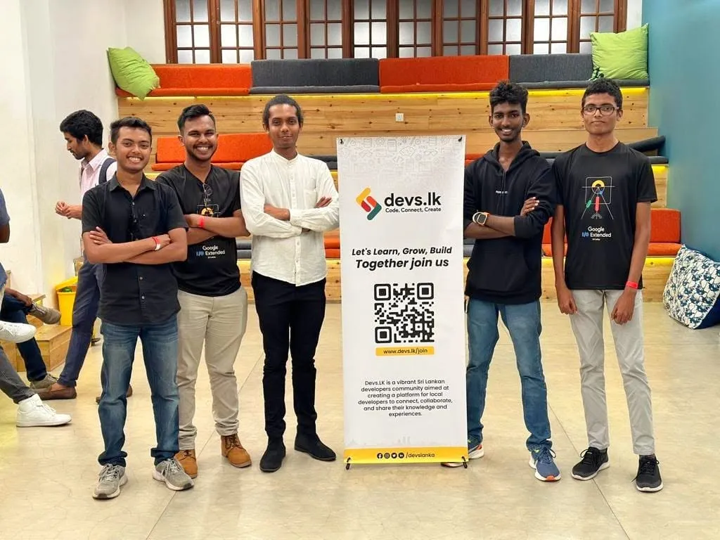 Devs.lk members standing with the Devs.lk banner at the Ceylon Bitcoin Meetup